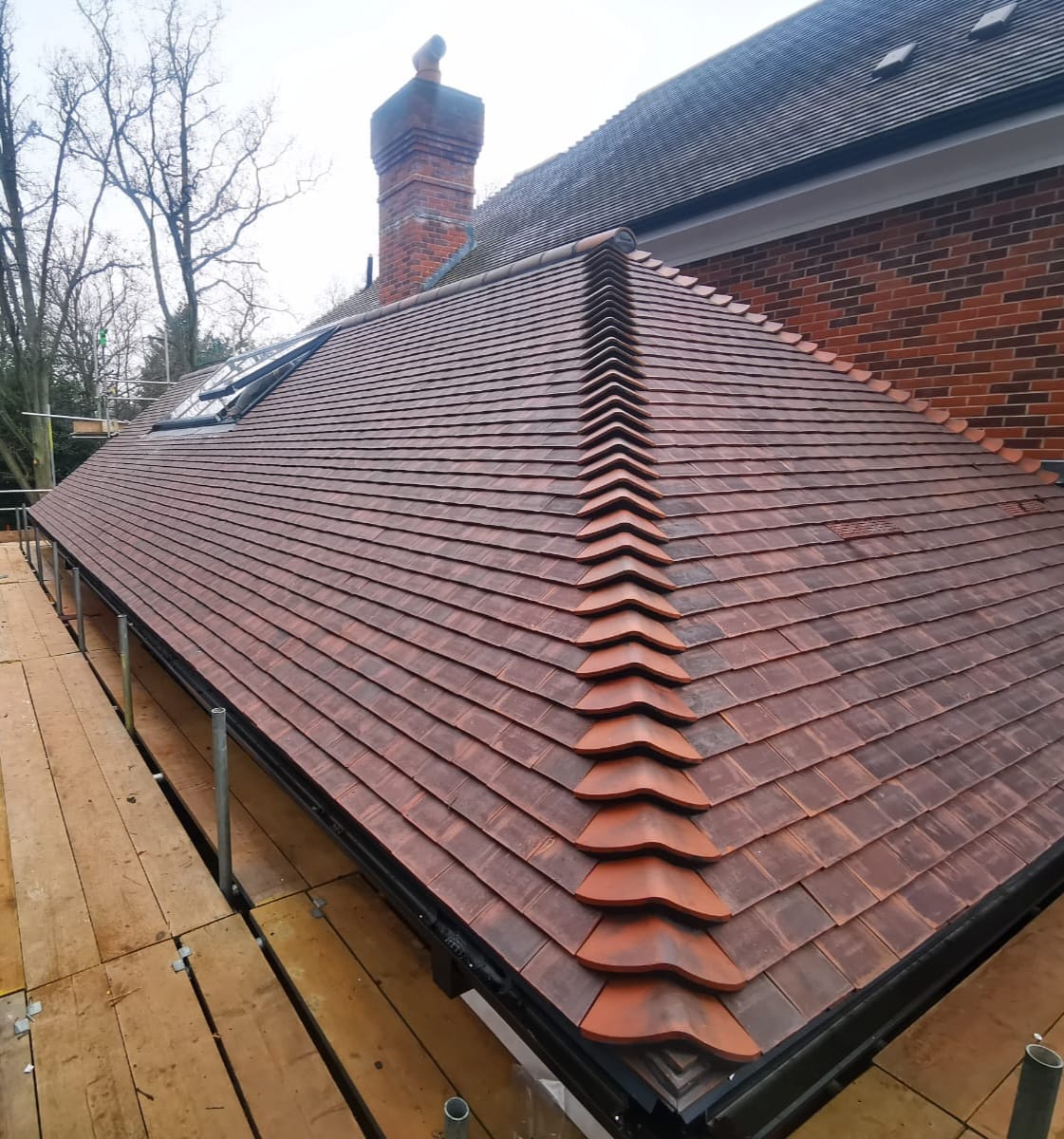 A newly laid natural-slate and tile roof on a stone house